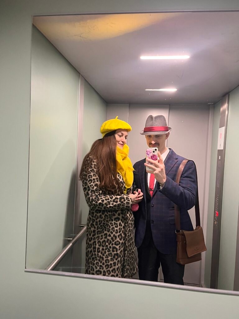 wife and husband dressed up in an elevator